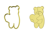Teddy bear holding heart cookie cutter with stamp
