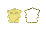 Two bears holding heart cookie cutter with stamp