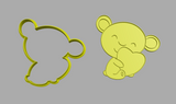 Cute teddy bear hugging a heart cookie cutter with stamp